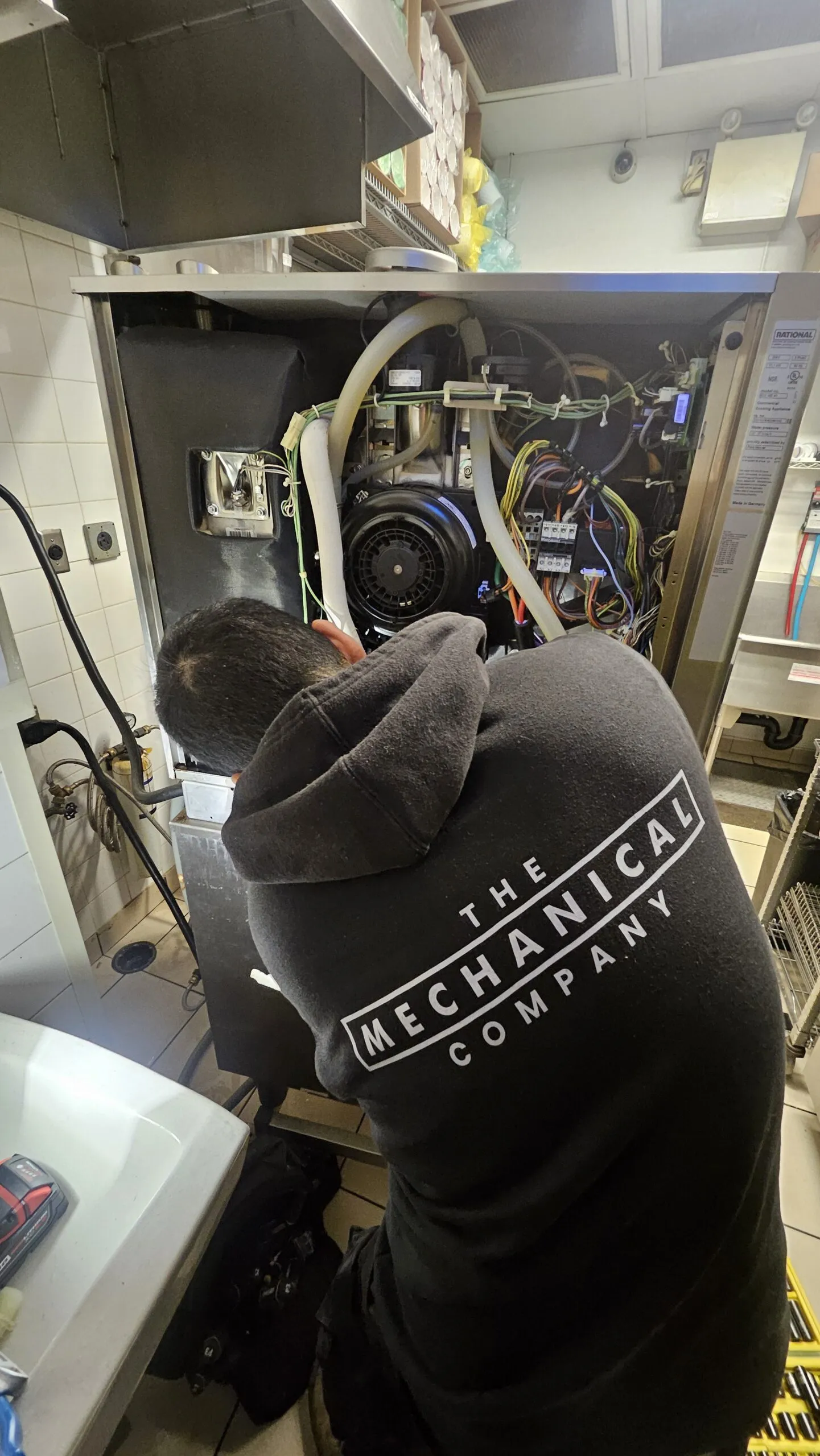 Technician repairing a Rational combi oven