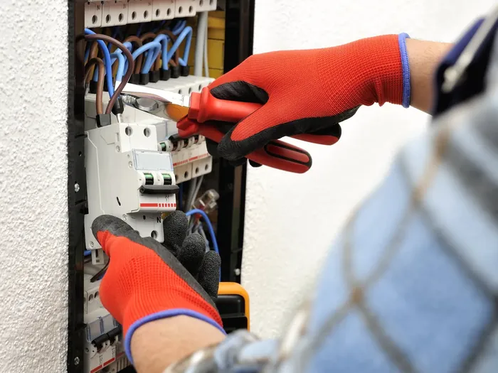 Electrician working on a commercial electrical panel